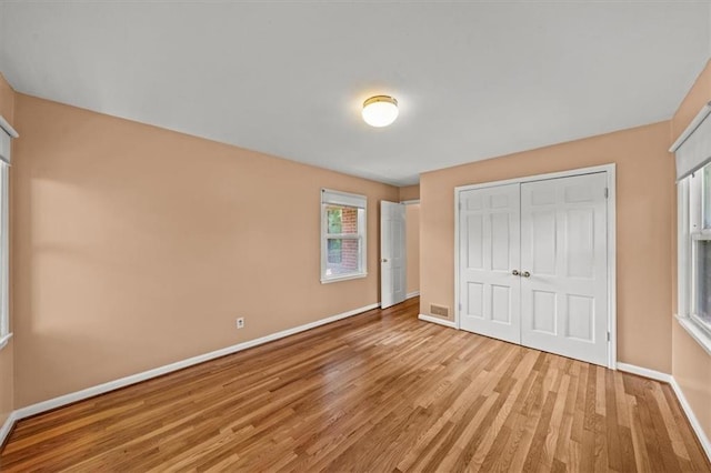 2306 Red Bridge Ter, Kansas City, MO 64131 - unfurnished bedroom featuring light wood-style floors, baseboards, and a closet