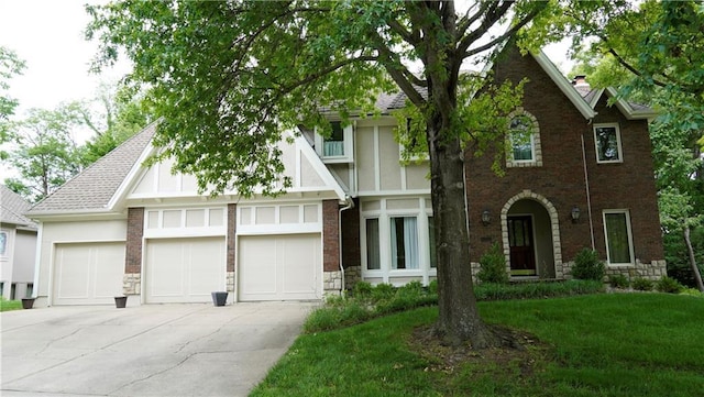5500 NW 62nd St, Kansas City, MO 64151 - tudor house featuring driveway, a garage, a chimney, brick siding, and roof with shingles