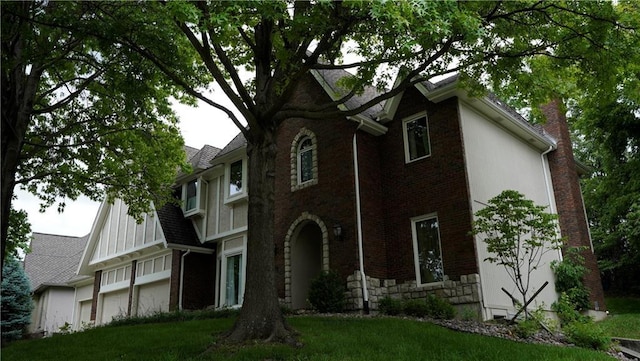5500 NW 62nd St, Kansas City, MO 64151 - tudor-style house featuring a chimney, brick siding, and stone siding