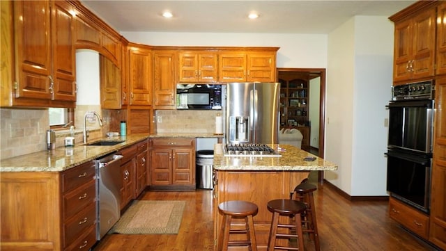 5500 NW 62nd St, Kansas City, MO 64151 - kitchen with black appliances, a sink, dark wood-style floors, a kitchen island, and recessed lighting