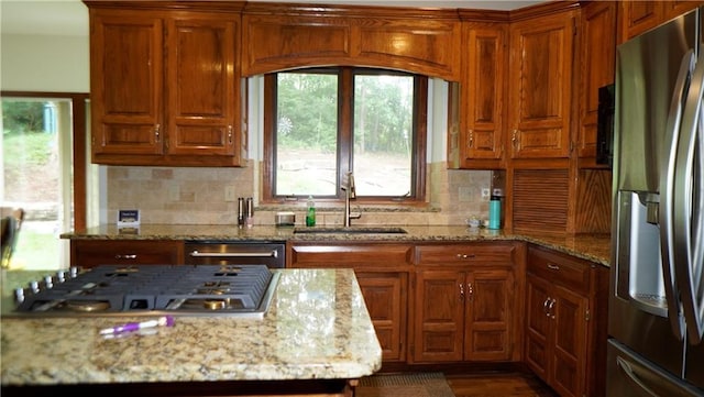5500 NW 62nd St, Kansas City, MO 64151 - kitchen with appliances with stainless steel finishes, a sink, plenty of natural light, and brown cabinets
