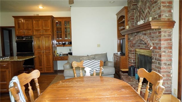 5500 NW 62nd St, Kansas City, MO 64151 - dining space with a brick fireplace and dark wood-style floors