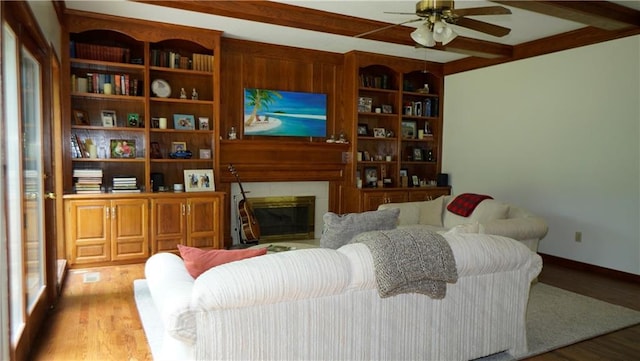 5500 NW 62nd St, Kansas City, MO 64151 - living area with a ceiling fan, wood finished floors, a fireplace, and beamed ceiling