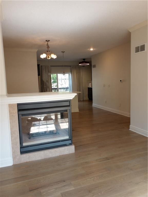 15829 W Robinson St, Overland Park, KS 66223 - interior space with baseboards, wood finished floors, a chandelier, crown molding, and recessed lighting