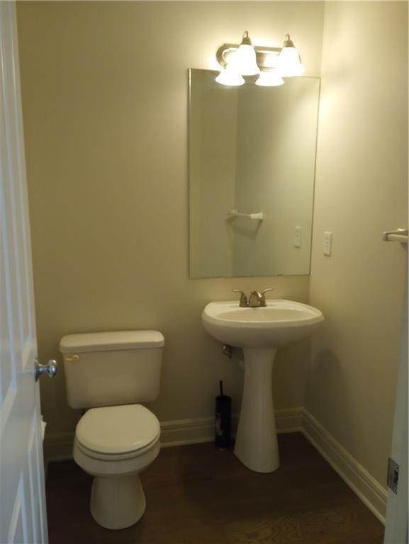 15829 W Robinson St, Overland Park, KS 66223 - half bath with baseboards, toilet, and wood finished floors