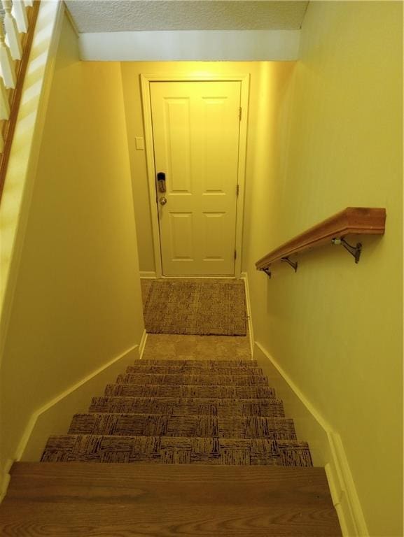 15829 W Robinson St, Overland Park, KS 66223 - stairway featuring baseboards and a textured ceiling