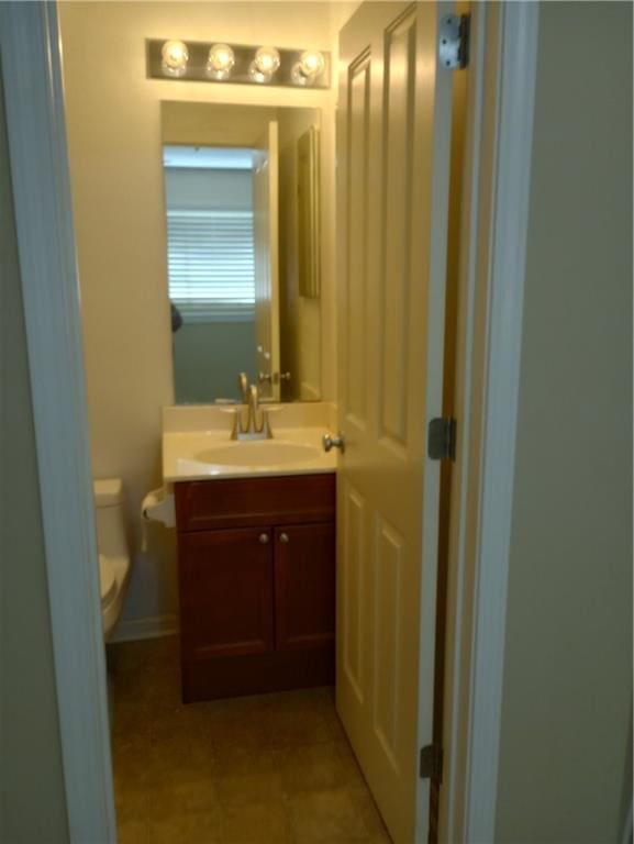 15829 W Robinson St, Overland Park, KS 66223 - half bath featuring vanity, toilet, and tile patterned floors