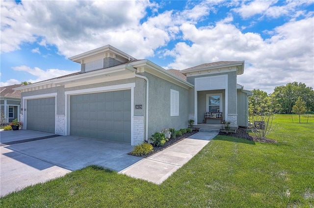 24129 W 95th St, Lenexa, KS 66227 - view of front of home featuring a front lawn, a garage, concrete driveway, and stucco siding