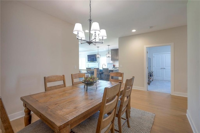 24129 W 95th St, Lenexa, KS 66227 - dining room featuring light wood-style flooring, baseboards, a chandelier, and recessed lighting