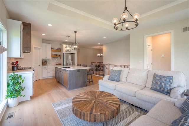 24129 W 95th St, Lenexa, KS 66227 - living room featuring a chandelier, light wood-type flooring, and recessed lighting