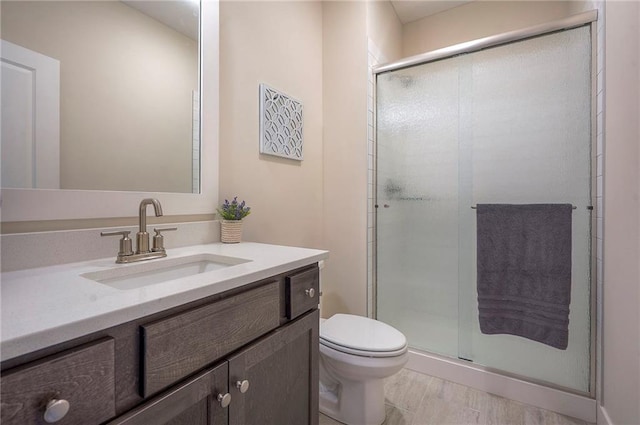 24129 W 95th St, Lenexa, KS 66227 - full bath featuring vanity, a shower stall, toilet, and wood finished floors