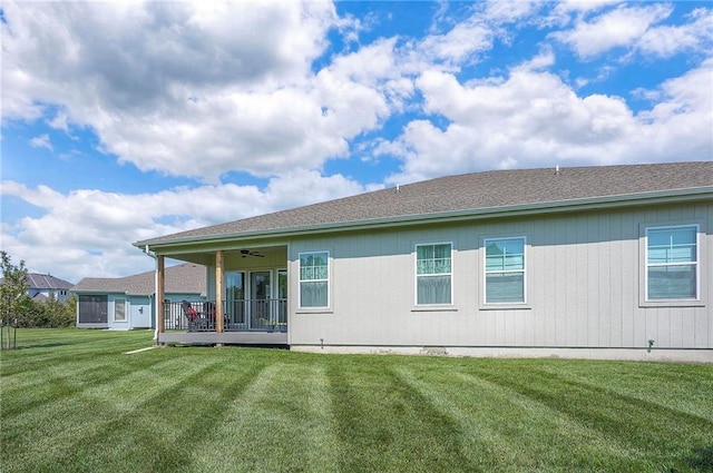 24129 W 95th St, Lenexa, KS 66227 - back of property featuring a ceiling fan, a lawn, and roof with shingles