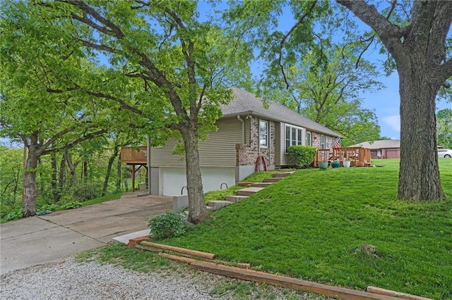 6525 County Line Rd, Shawnee, KS 66216 - view of side of home with an attached garage, driveway, a lawn, and a deck