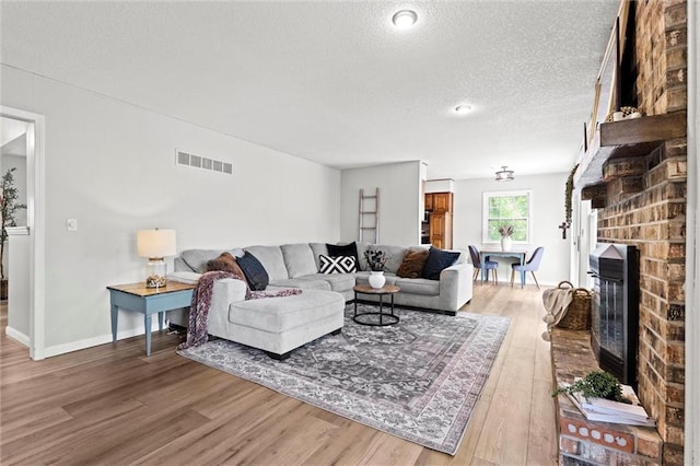 6525 County Line Rd, Shawnee, KS 66216 - living room featuring a textured ceiling, wood finished floors, and a fireplace