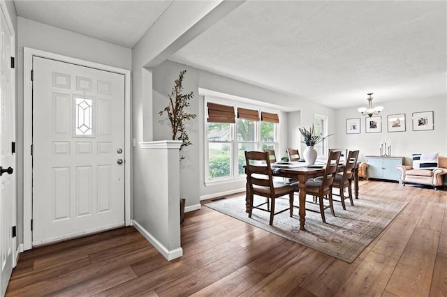 6525 County Line Rd, Shawnee, KS 66216 - dining space with a chandelier, a textured ceiling, and hardwood / wood-style flooring