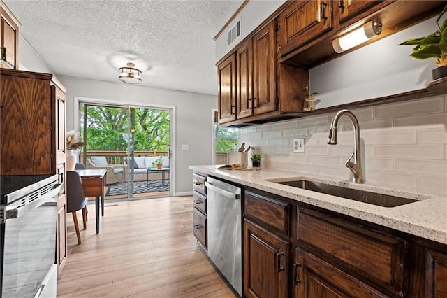 6525 County Line Rd, Shawnee, KS 66216 - kitchen with stainless steel dishwasher, decorative backsplash, light wood-style floors, wall oven, and light stone countertops