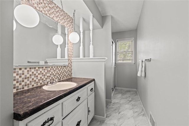 6525 County Line Rd, Shawnee, KS 66216 - bathroom with marble look tile flooring, vanity, tasteful backsplash, and a shower stall
