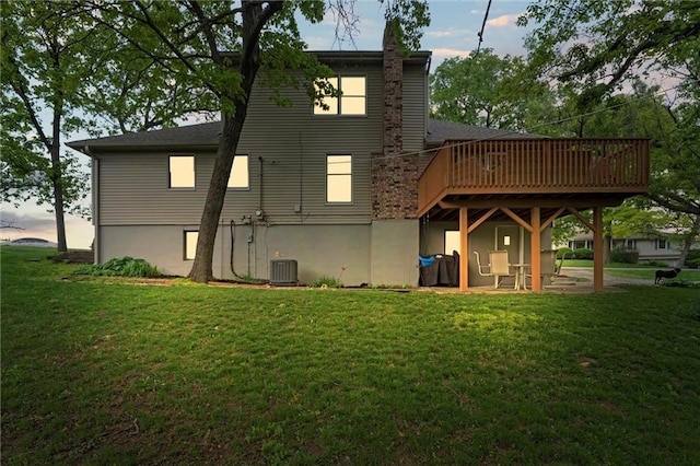 6525 County Line Rd, Shawnee, KS 66216 - back of house at dusk with a yard and a deck