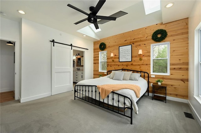 24905 W 57th St, Shawnee, KS 66226 - carpeted bedroom with a skylight, a barn door, wood walls, baseboards, and recessed lighting