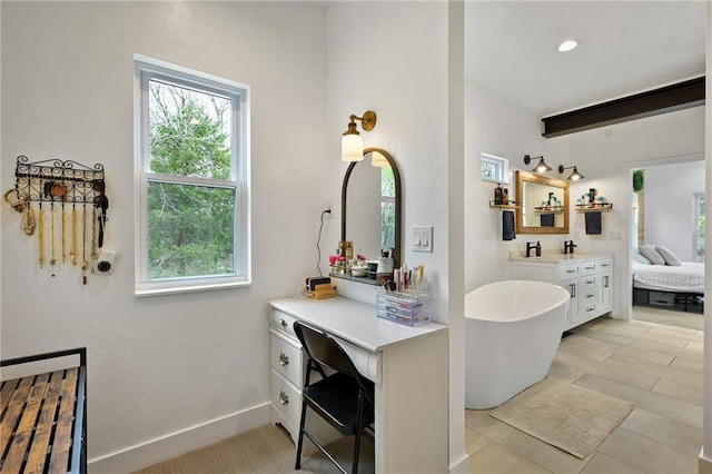 24905 W 57th St, Shawnee, KS 66226 - ensuite bathroom with plenty of natural light, a freestanding bath, vanity, beamed ceiling, and baseboards