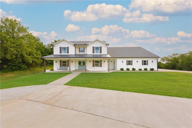 24905 W 57th St, Shawnee, KS 66226 - modern farmhouse with a front yard, a porch, metal roof, and french doors