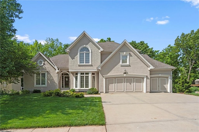 14913 W 72nd St, Shawnee, KS 66216 - traditional home featuring concrete driveway, a front lawn, stucco siding, and an attached garage