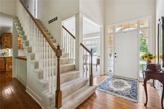 14913 W 72nd St, Shawnee, KS 66216 - foyer with a towering ceiling, wood finished floors, stairs, and decorative columns