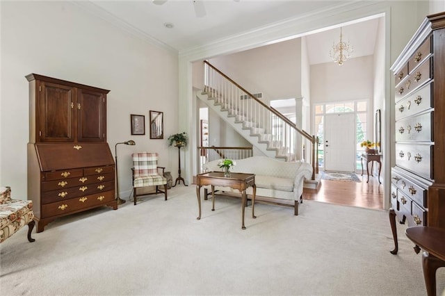 14913 W 72nd St, Shawnee, KS 66216 - living area with light carpet, stairs, ornamental molding, a chandelier, and a towering ceiling