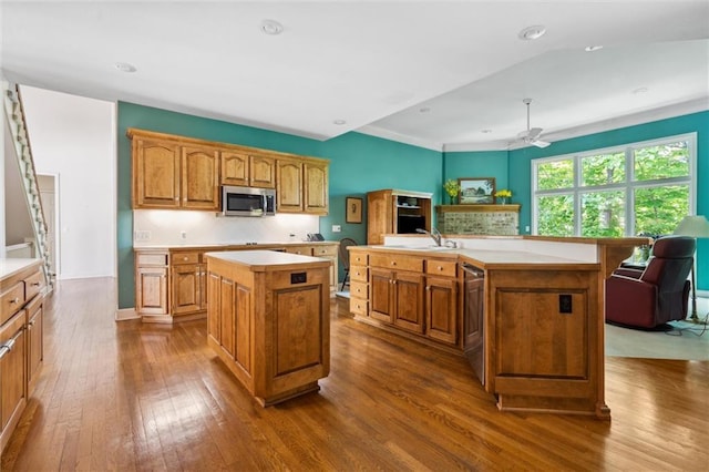 14913 W 72nd St, Shawnee, KS 66216 - kitchen featuring an island with sink, appliances with stainless steel finishes, dark wood-style floors, light countertops, and recessed lighting