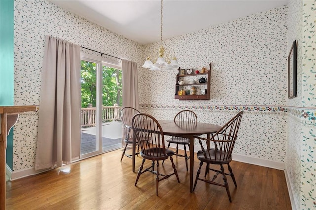 14913 W 72nd St, Shawnee, KS 66216 - dining space with wallpapered walls, a chandelier, and wood finished floors