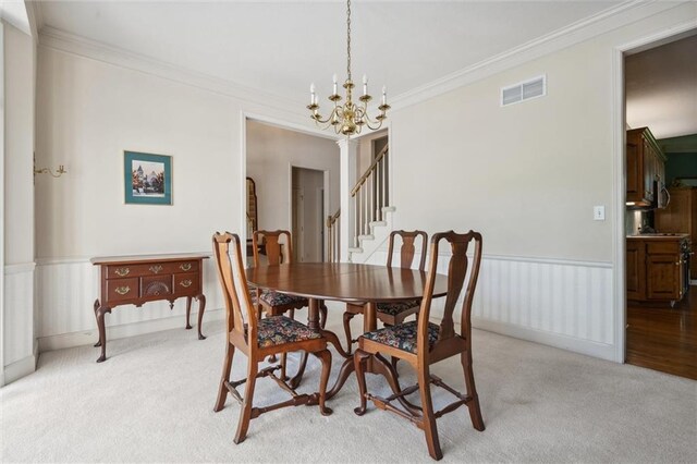 14913 W 72nd St, Shawnee, KS 66216 - dining area with a chandelier, light carpet, ornamental molding, stairs, and a wainscoted wall