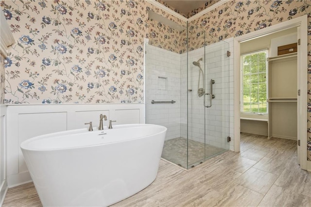 14913 W 72nd St, Shawnee, KS 66216 - full bathroom featuring wallpapered walls, a shower stall, wainscoting, and a soaking tub