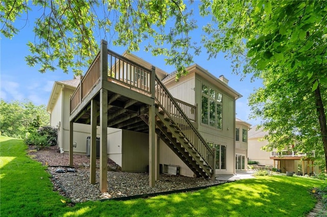 14913 W 72nd St, Shawnee, KS 66216 - back of property featuring a wooden deck, stairs, a lawn, and a jacuzzi