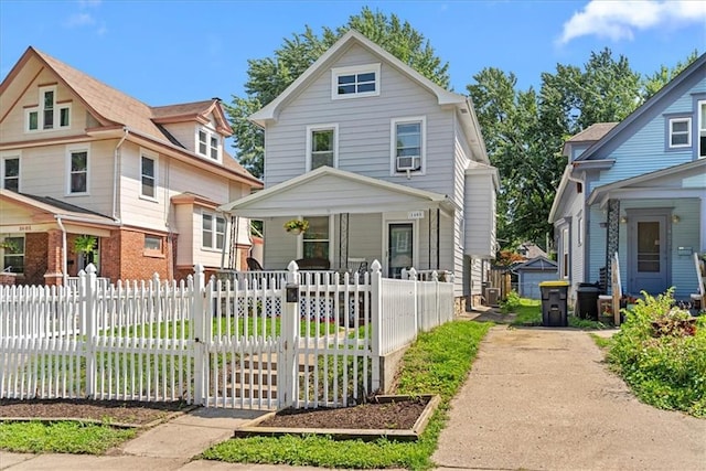 1405 W 40th St, Kansas City, MO 64111 - view of front of house with a porch and a fenced front yard