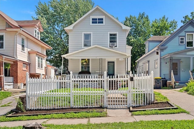 1405 W 40th St, Kansas City, MO 64111 - american foursquare style home with covered porch, a gate, and a fenced front yard