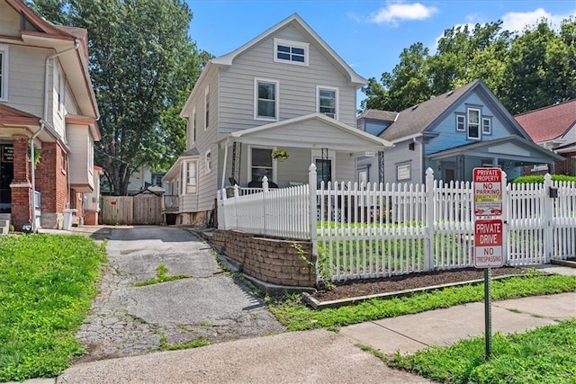1405 W 40th St, Kansas City, MO 64111 - view of front of property with a porch, driveway, and a fenced front yard