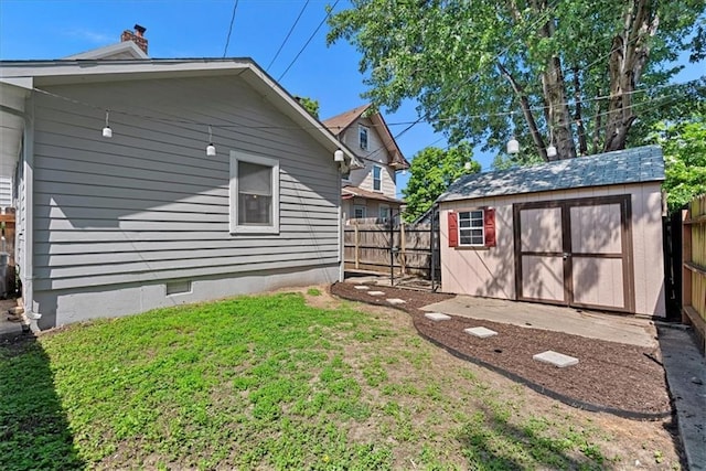 1405 W 40th St, Kansas City, MO 64111 - view of property exterior featuring a chimney, a fenced backyard, a storage shed, and crawl space