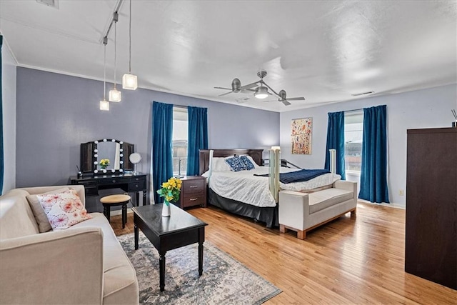 1405 W 40th St, Kansas City, MO 64111 - bedroom featuring multiple windows, light wood-style flooring, track lighting, and ceiling fan