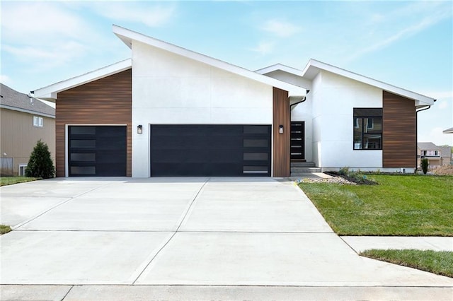 8316 NW 89th Ter, Kansas City, MO 64153 - contemporary home featuring a garage, driveway, a front yard, and stucco siding
