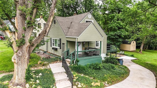 5103 NE Marvin Rd, Kansas City, MO 64118 - view of front facade featuring a front lawn and roof with shingles