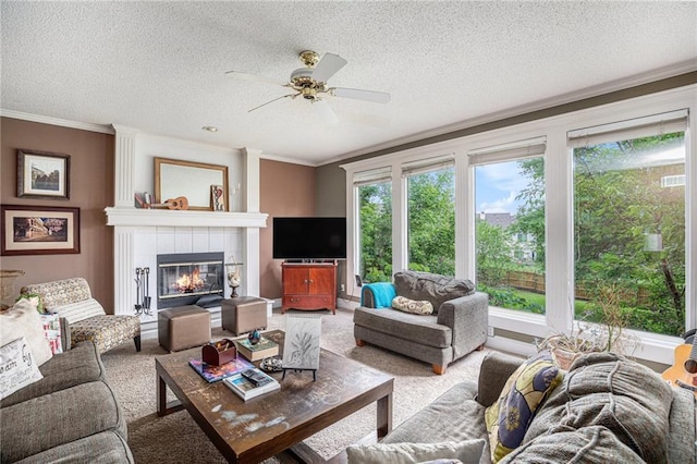1515 Fox Run Ln, Raymore, MO 64083 - living area featuring crown molding, a textured ceiling, ceiling fan, a fireplace, and carpet