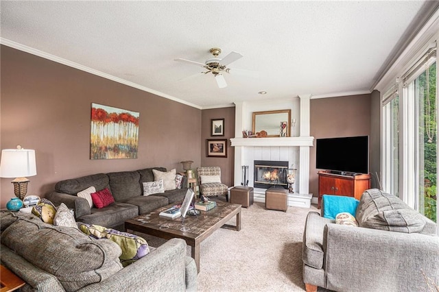 1515 Fox Run Ln, Raymore, MO 64083 - carpeted living area featuring a ceiling fan, ornamental molding, a tiled fireplace, and a textured ceiling
