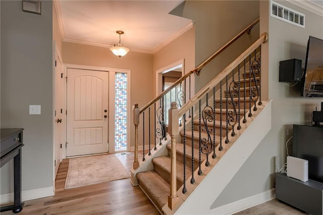 2208 SW Hawk View Rd, Lees Summit, MO 64082 - foyer entrance with ornamental molding, wood finished floors, baseboards, and stairway