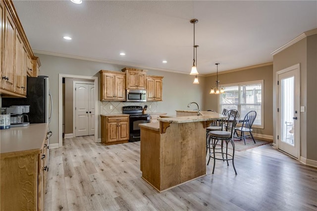 2208 SW Hawk View Rd, Lees Summit, MO 64082 - kitchen with black electric range oven, stainless steel microwave, a breakfast bar area, light wood-type flooring, and baseboards