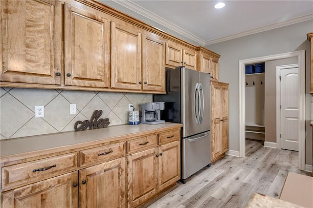2208 SW Hawk View Rd, Lees Summit, MO 64082 - kitchen featuring freestanding refrigerator, backsplash, crown molding, light wood-style floors, and light countertops