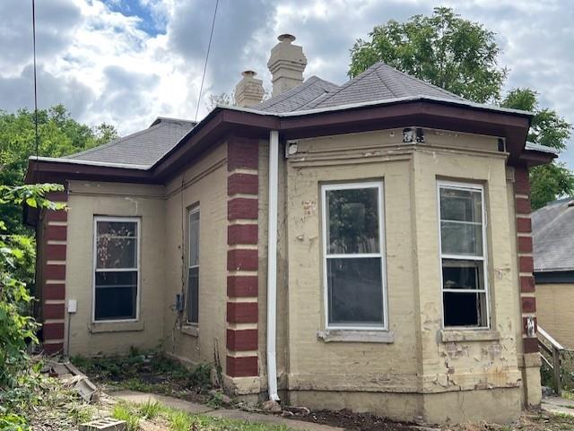 515 N 11th St, Saint Joseph, MO 64501 - view of property exterior with a chimney and a shingled roof