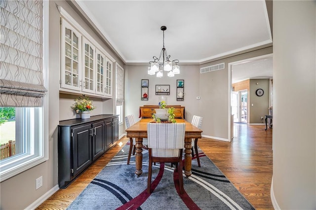 7905 W 129th St, Overland Park, KS 66213 - dining room with wood finished floors, a chandelier, baseboards, and ornamental molding