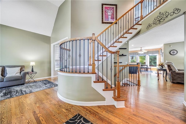 7905 W 129th St, Overland Park, KS 66213 - stairway featuring high vaulted ceiling, wood finished floors, and baseboards