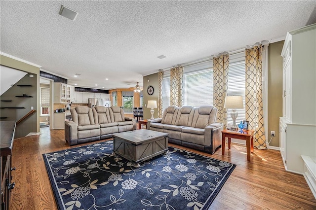 7905 W 129th St, Overland Park, KS 66213 - living room with ornamental molding, wood finished floors, a textured ceiling, baseboards, and a ceiling fan