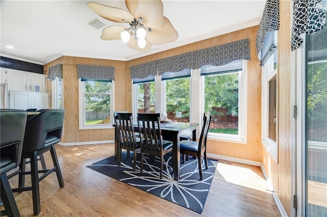 7905 W 129th St, Overland Park, KS 66213 - dining area featuring light wood-style floors, ornamental molding, baseboards, plenty of natural light, and ceiling fan